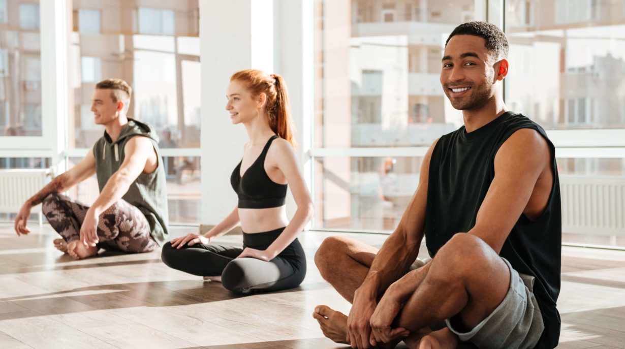 men and women doing pilates and yoga